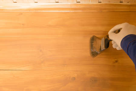 a man in a protective suit and mask took a soil sample from the bottom of the river into a Petri dishの写真素材
