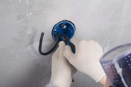 strengthening the base of the electrical outlet before installing contacts, close-up of the master's...