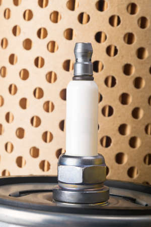against the background of a paper filter spark plug for a motorの写真素材