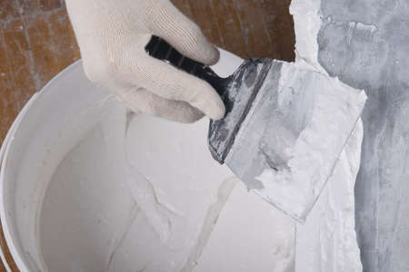 on a large spatula apply a mixture for sealing cracksの写真素材