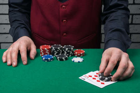 the dealer's hands opened the winning combination of cards on the green cloth of the poker table, close-upの写真素材