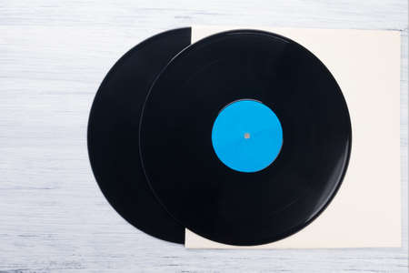 two old vinyl records lie on paper packaging, top view