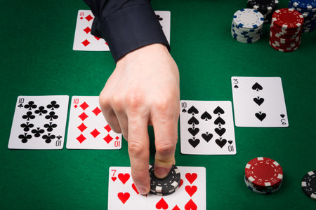 the croupier's hand on the table shows the addition of chips to the player with the winning...