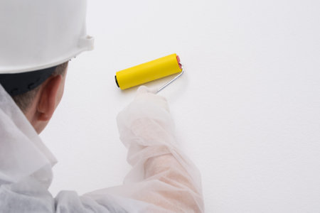 wall repairman finishes wallpapering, close-upの写真素材