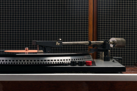 equipment for listening to vinyl records on a brown table, side view