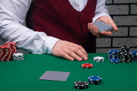 the croupier deals cards to the blackjack playersの写真素材