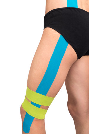 fixing leg muscles with medical tape, isolated on white, side viewの写真素材