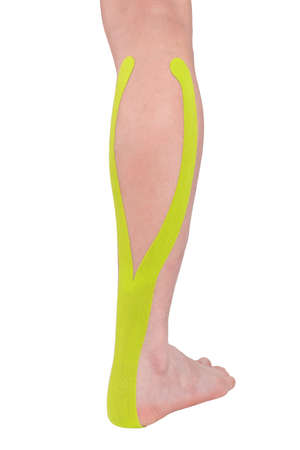 green plaster pasted on calf muscle for pain, isolated on whiteの写真素材
