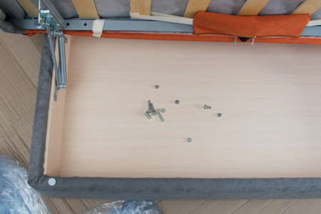 screws and nuts in the open drawer of the sofa orangeの写真素材