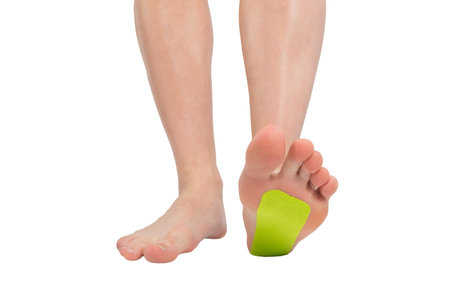 on a white background, the leg, on the foot tapedの写真素材