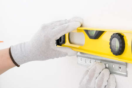 level aligns fasteners for kitchen cabinets, close-up