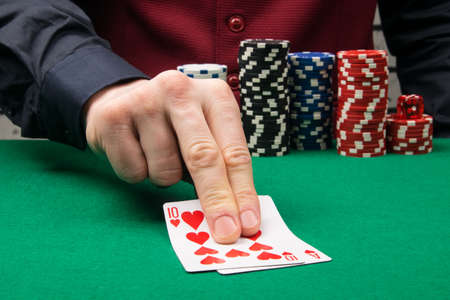 two blackjack playing cards on the green baize table in the casinoの写真素材