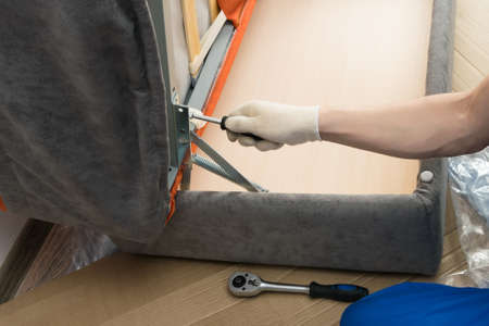 delivery and assembly of the sofa at the buyer, close-upの写真素材