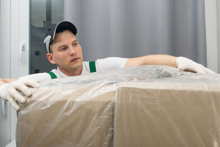 the courier delivered a large parcel to the customerの写真素材