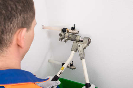 installation of metal cranes on polyethylene pipes with special equipment, rear viewの写真素材