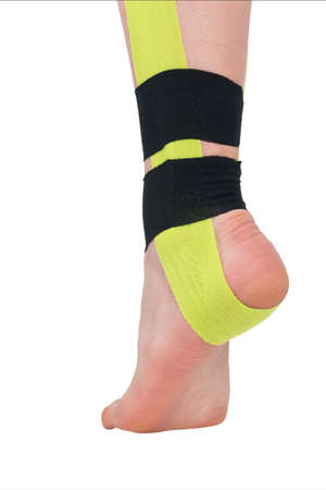 relief of pain in the lower leg with medical tape, isolated on whiteの写真素材