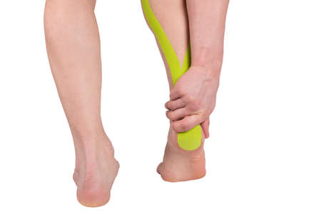 relief of pain in the lower part of the foot with medical tape, isolated on whiteの写真素材