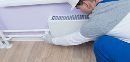 master of heating system maintenance, adjusts the automatic temperature sensorの写真素材