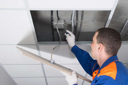 the master unwinds the electrical junction box, to repair the hidden wiring in the ceilingの写真素材