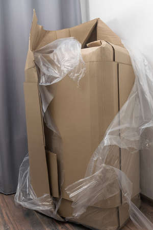 torn large box indoors against the wallの写真素材