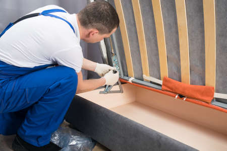 assembly of new upholstered furniture in the buyer's homeの写真素材