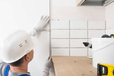 fixing the side aluminum strip to protect the ceramic tiles on the wallの写真素材