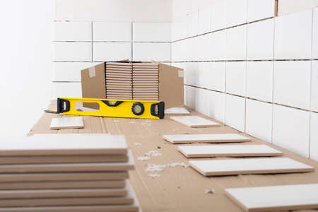 workstation and tool for laying tiles over kitchen furniture on the wallの写真素材