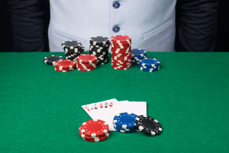 poker chips and cards on the green tableの写真素材