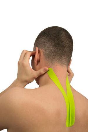 for pain in the cervical vertebrae and headaches, the athlete pasted a fixing tape to relieve spasmsの写真素材