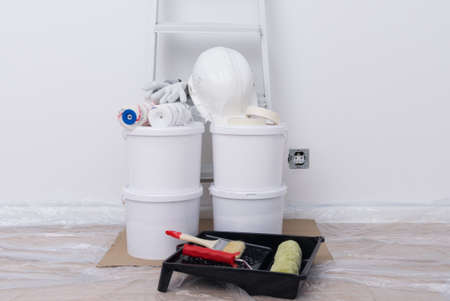 materials and tools in a pile, against a white wall before work, buckets, rollers, brushesの写真素材