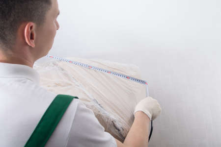 measurement of bulky cargo by a working courier before sending, there is a place for the inscriptionの写真素材