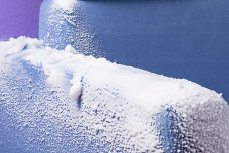 the armrest of the blue sofa, covered with thick foam for cleaning old dirt, close-upの写真素材