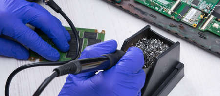 on a light table, the laptop circuit is checked by a tester for the presence of malfunctions and diagnostics, close-upの写真素材