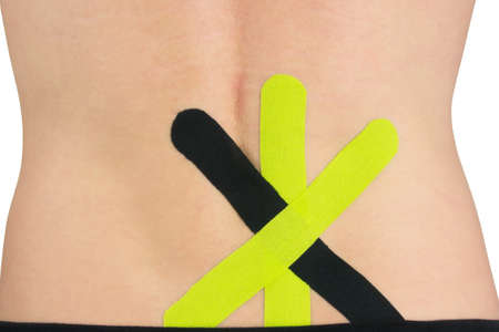 on the back of the back, a tape is pasted to facilitate the relief of lower back painの写真素材