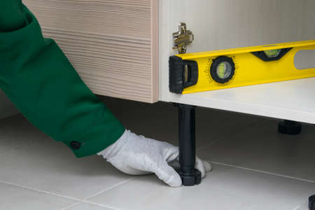 close-up of adjusting the correct installation of the cabinet, kitchen furnitureの写真素材