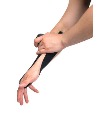 the process of applying the black tape on the hand, to protect against injury when playing sports, there is a place for the inscriptionの写真素材