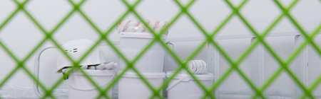 photo background taken through a grid, a set of tools for painting walls, rollers, buckets of paint and a protective helmetの写真素材