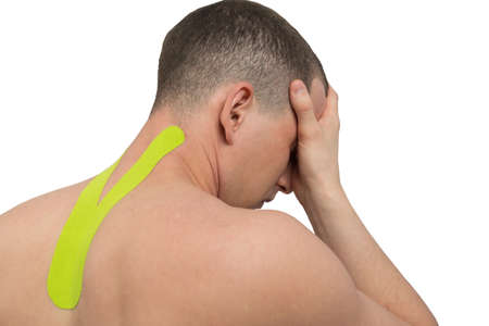 headache and pressure due to displacement of the cervical vertebrae, relieving the load with tapeの写真素材