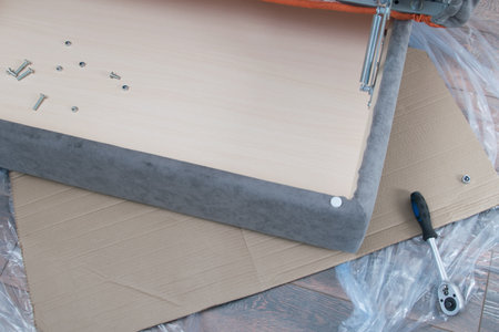 background with a place for an inscription, on the inner drawer of the sofa with items for assembly and repair, a key, screwsの写真素材