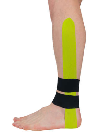 a fixing tape is pasted on the ankle, for pain in the joints and musclesの写真素材