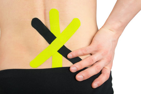 on the back of the back, taped to relieve lower back pain, after injuryの写真素材