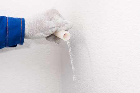 hand draining water from XLPE pipe, close-upの写真素材