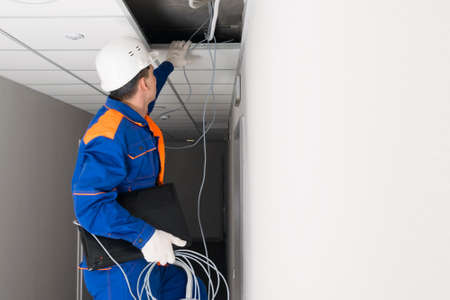 a worker performs technical work on setting up the Internet in homes and officesの写真素材
