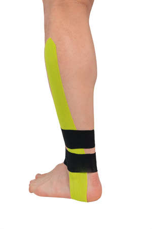 leg with medical tape glued to fix it, isolated on whiteの写真素材