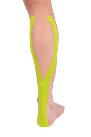 leg with medical tape glued on, isolated on whiteの写真素材
