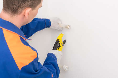 a worker cuts a XLPE pipe for a plumbingの写真素材