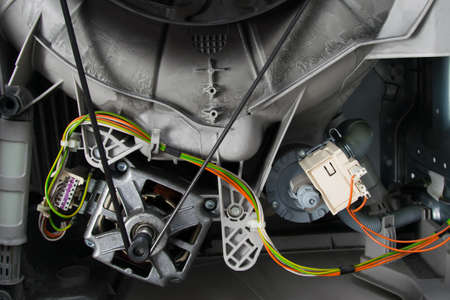 close-up of the internal structure of the washing machine, the engine and electrical wiring with the contact groupの写真素材