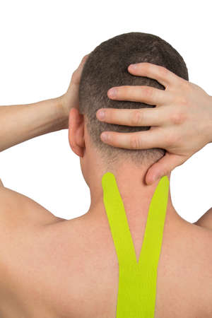 headache and pressure due to displacement of the cervical vertebrae, lifting the load with the help of tapesの写真素材