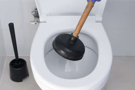 close-up of the elimination of the blockage of the toilet sewerの写真素材