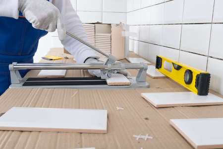 close-up of the cutting, according to the size of the tiles for installation on the wallの写真素材